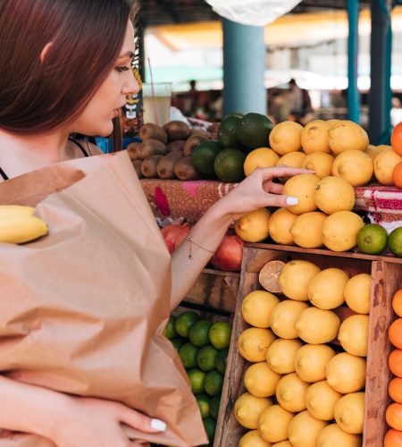 close-up-woman-holding-paper-bag_23-2148238098